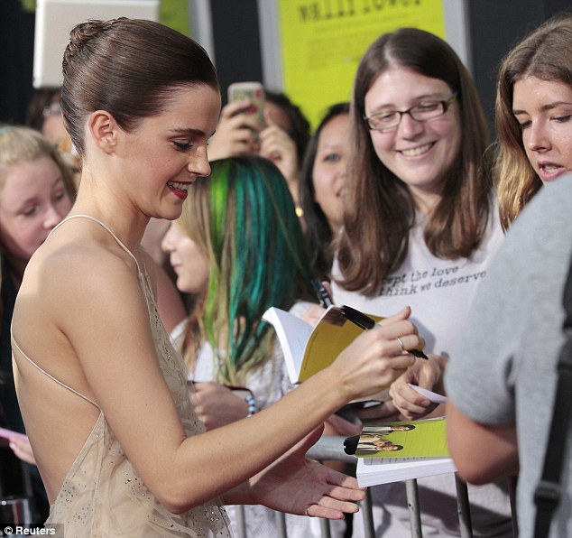 Lady of the night: Emma dutifully signed autographs for loyal fans