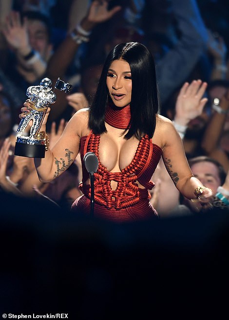 Delight: Beaming with excitement, Cardi told the crowds: 'Hold on, wait a minute. This is a video music award, I really want to thank my music video team, the director and everything