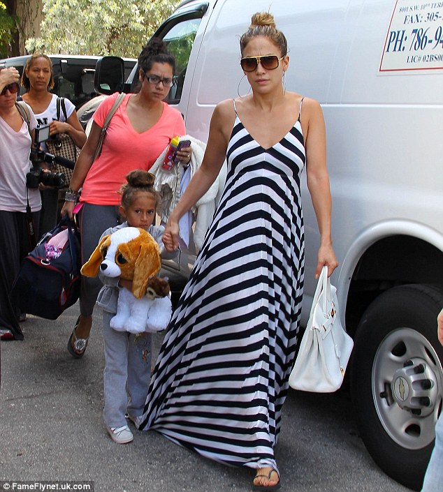 A different kind of wardrobe malfunction: Emme stpped on her mother's dress as they arrived at their hotel