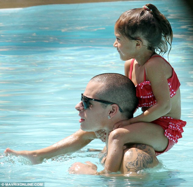 Playing stepdad: Casper Smart carries four-year-old Emme on his shoulders