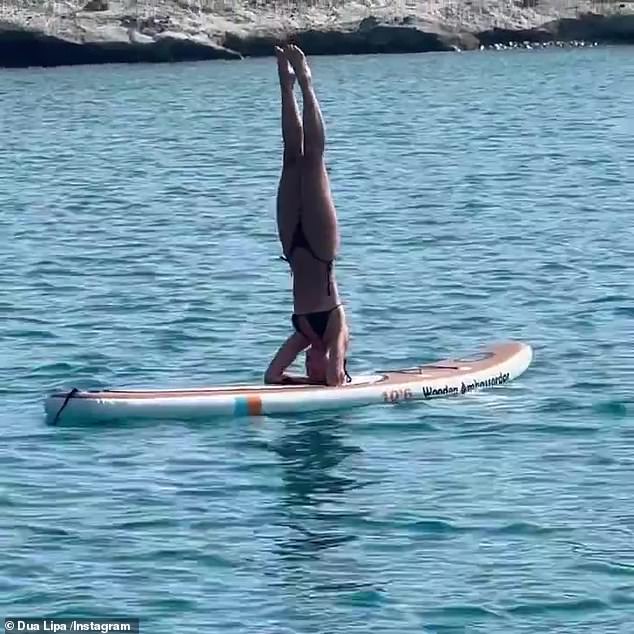 Fun: Taking to Instagram on Friday, the brunette beauty flaunted her stunning physique and threw herself into the fun as she showed off her paddle boarding skills