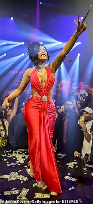 The Bronx-born 30-year-old flaunted her surgically-enhanced cleavage in a plunging red gown selected by stylist Kollin Carter