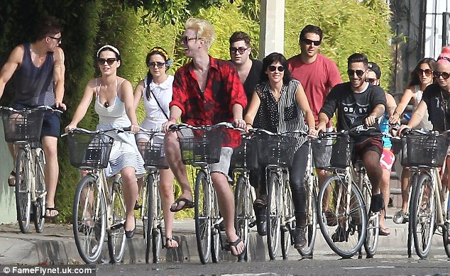 We're with Katy: The singer certainly had an entourage as she biked around with a large group of friends