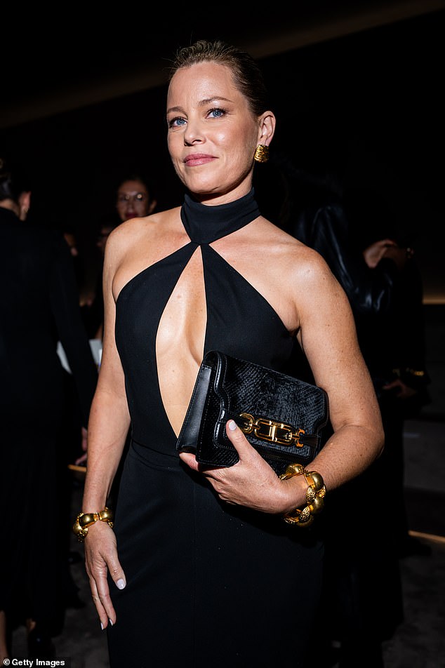 Oozing class: The Walk Of Shame actress sizzled in the strapless garment - which featured a very plunging cut-out V-neckline and a turtleneck collar