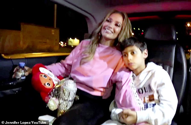 'I am happy it's over. It's hard work for me': Later in the YouTube video, JLo finishes the It's My Party Tour and heads home with her fiancé Alex Rodriguez and 11-year-old twins Emme & Max Muñiz (R)