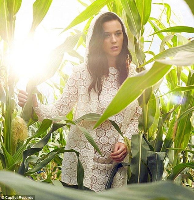 Tropical: The star chose a pretty lace dress as she stands among large plants