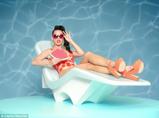 Unique: Then out comes the pepperoni pizza swimsuit as the singer lounges while biting into a huge chunk of watermelon
