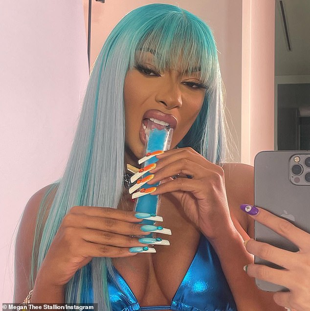 Iced out: The rapper enjoyed a blue ice pop and showed off her manicure