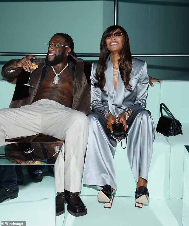 All smiles: Naomi appeared to be in good spirits as she flashed a huge grin at the show, where she sat alongside singer Burna Boy