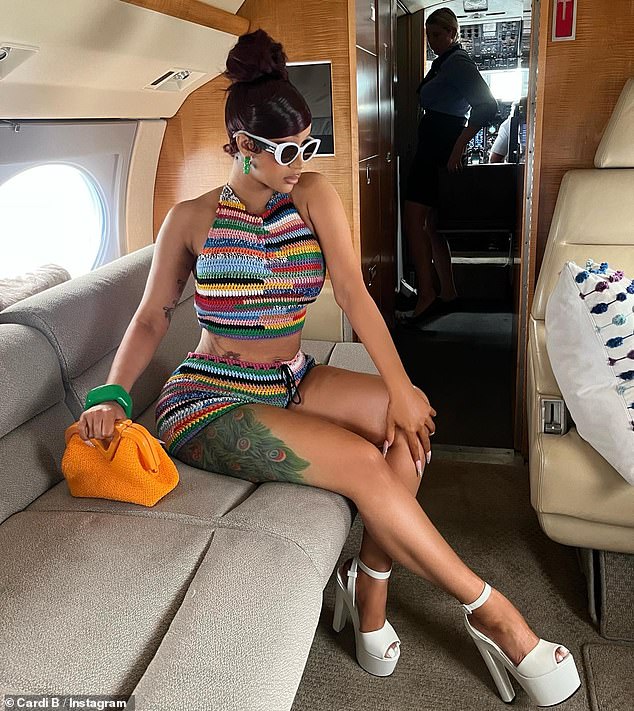 Stylish: On Saturday, the 29-year-old rapper shared a slideshow of photos in which she was seen showing off her colorful Miu Miu outfit as she jetted off for a Memorial Day Weekend vacation with husband Offset