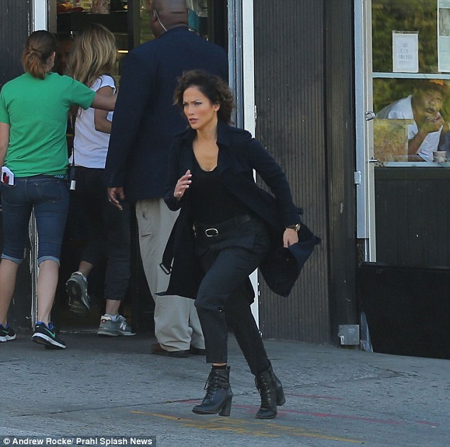 Running shoes: JLo was outfitted in a coat, dark trousers and clingy top along with lace-up boots