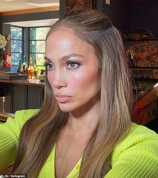 Radiant: She led with her 'JLo glow' as she showed off dewy skin and glossy lips with light eye makeup accentuating her brown eyes