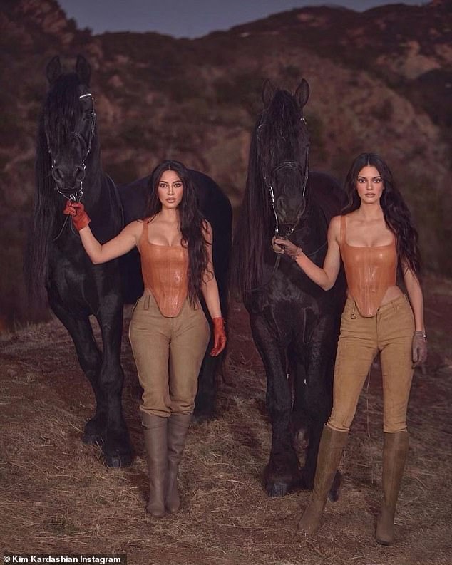 Giddy up: The reality stars wowed wearing matching in leather corsets which accentuated their already awe-inspiring curves via structured silhouette as they posed besides two stunning black Friesian horses