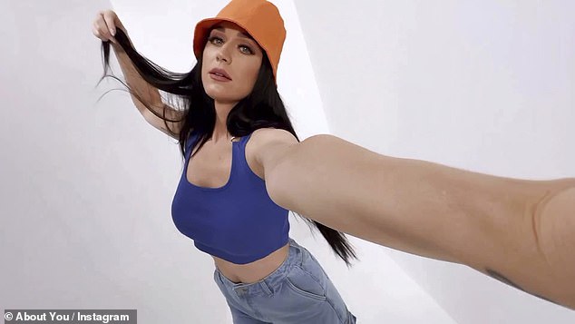 Wow: She looked vibrant in a burnt orange bucket hat and royal blue crop top, which were paired with wide-leg jeans