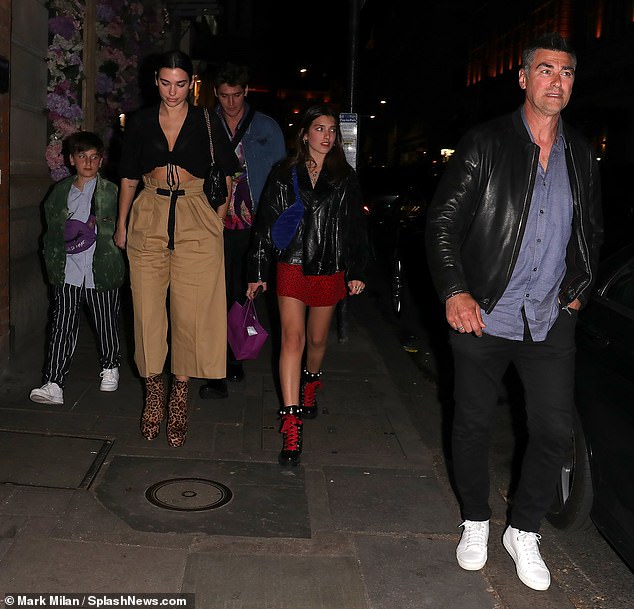 Happy days: Dua Lipa proved she is still a family girl at heart as she emerged for a family dinner on Tuesday evening to celebrate her sister Rina's 18th birthday alongside her brother Gjin, 14, her beau Isaac Carew, 32, and her famously hunky dad Dukagjin