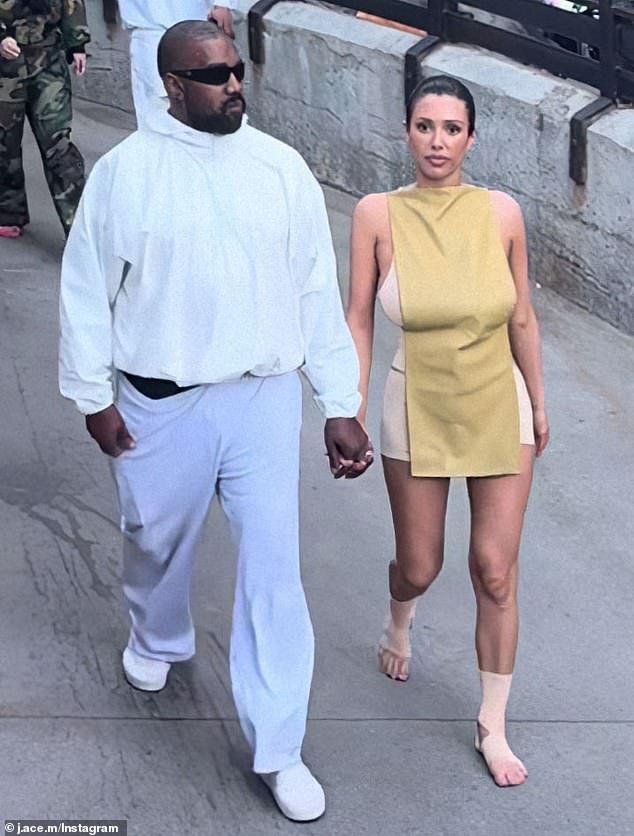 Kanye West Ditches His Usual All-black Look For White Sweatshirts As Wife Bianca Censori Goes BAREFOOT As They Join The Crowds To Visit Disneyland.