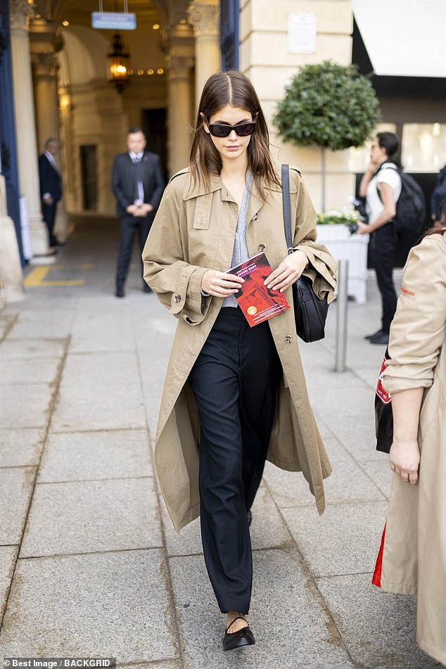 Oozing style: Kaia Gerber, 22, looked effortlessly chic in a beige trench coat as she stepped out during Paris Fashion Week