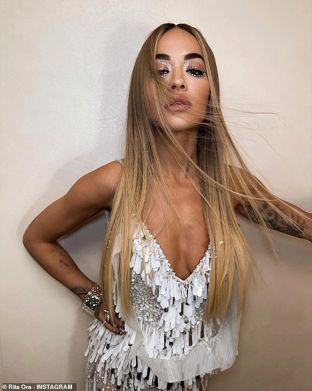 Wow: Rita Ora, 32, looked sensational as she cut a glam look in bejewelled eye makeup and a white tᴀssel mini dress for recent Instagram snaps on Friday