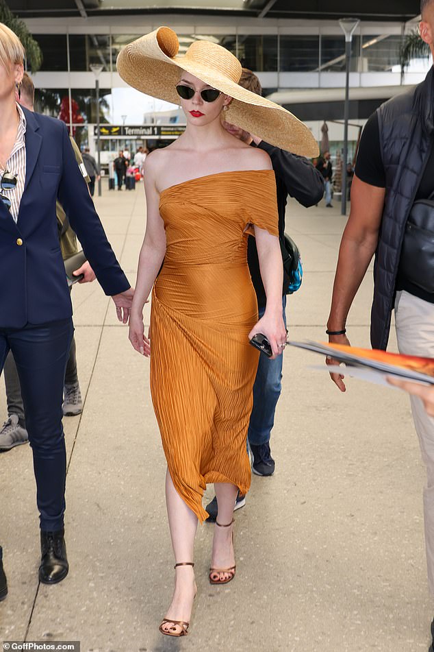 Anya Taylor-Joy, 28, made a statement in a mustard yellow dress as she touched down in France on Monday, just a day before Cannes Film Festival kicks off