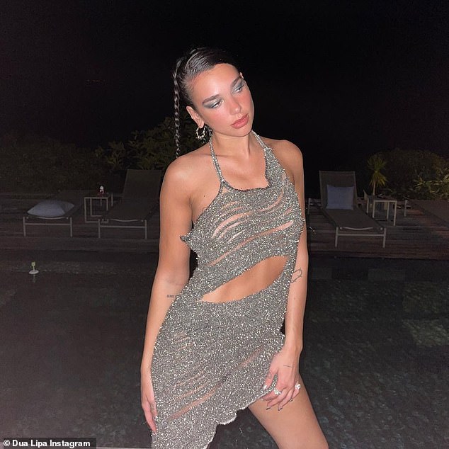 Wow: Dua Lipa looked sensational in a shimmering silver sequin dress as she continued her New Year break in St. Barts on Monday