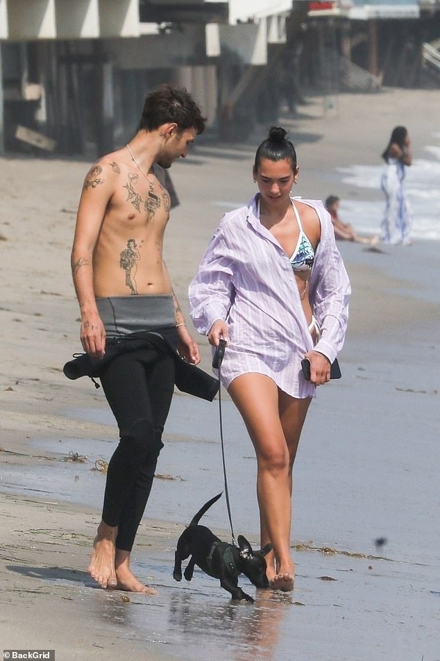 Beach babe: Dua Lipa showed off her slender figure in a colourful ʙικιɴι as she enjoyed a day out at the beach with beau Anwar Hadid to take their dog Dex for a walk on Tuesday