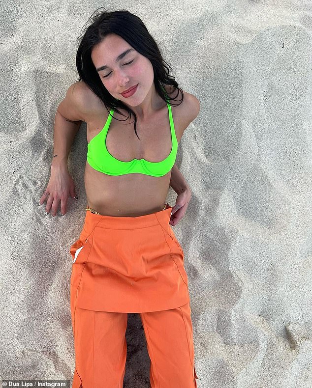 Looking good: Newly-single Dua Lipa showcased her incredible figure in a neon ʙικιɴι and bright orange trousers in a slew of snaps she shared on Instagram on Friday