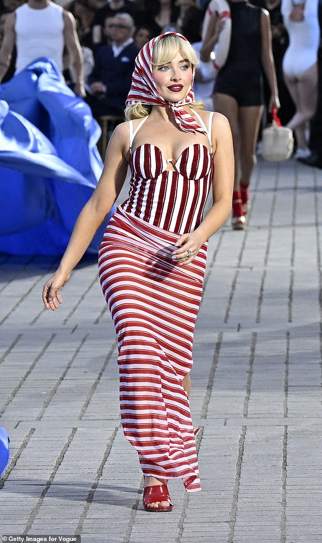 She pulled the ultimate pose as she walked around the centerpiece in red and white striped beachwear