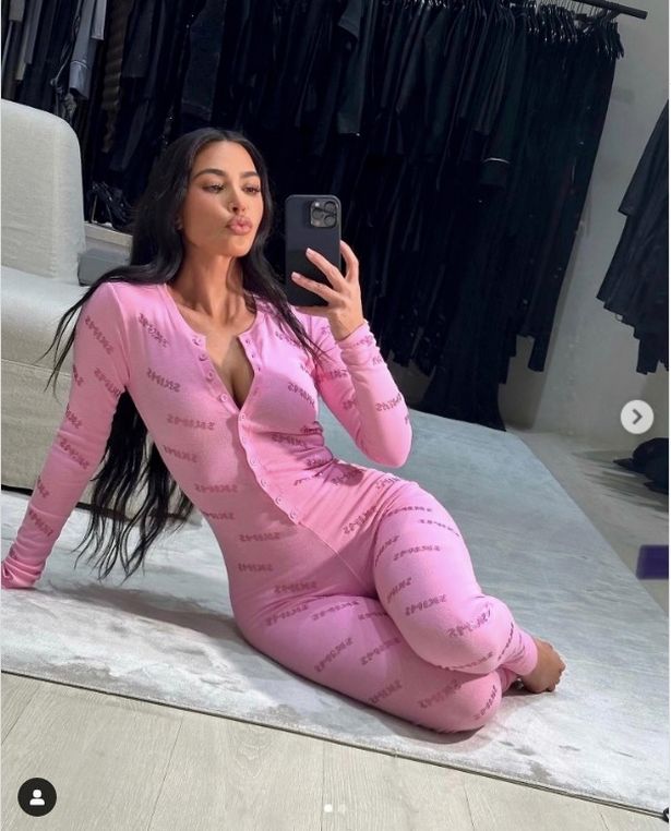 Kim Kardashian appeared to go braless in a SKIMS branded onesie