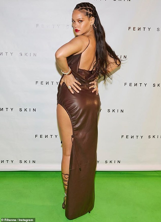 Leggy display: Rihanna put on a leggy display Thursday in a sizzling brown leather dress with spaghetti straps and a thigh-high leg slit for the red carpet of the Fenty Skin virtual launch